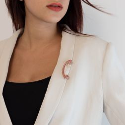 Photo of worn C-shaped Brooch with 69 Rubies in Yellow gold