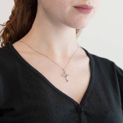 Wavy Cross Pendant 13 Diamonds on half photo of worn