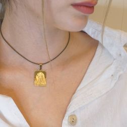 Photo of worn Madonna of the Finger yellow gold pendant