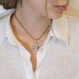 Photo of worn Virgin Mary and baby Jesus pendant white gold