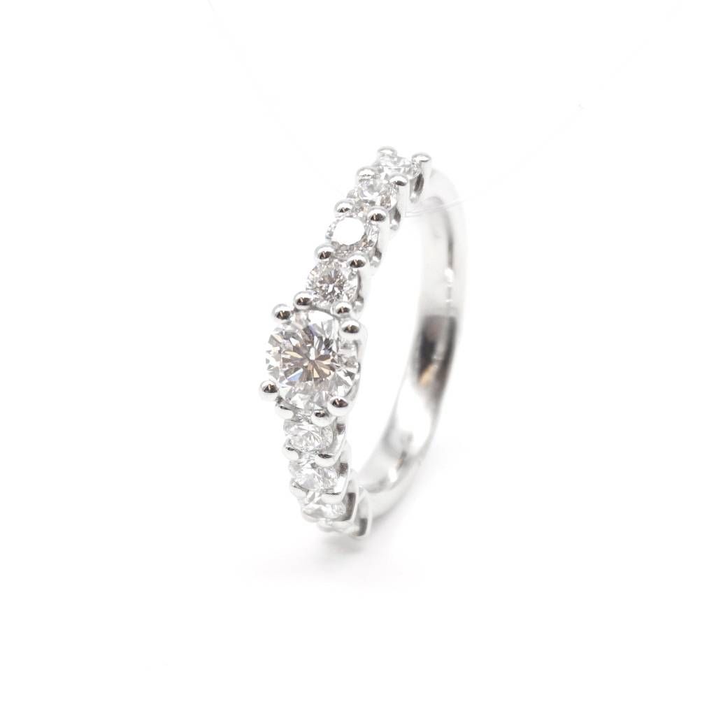 Platinum solitaire ring with diamonds on the shank and central GIA diamond 0.61 ct.