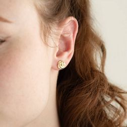 Photo of worn yellow gold rose earrings