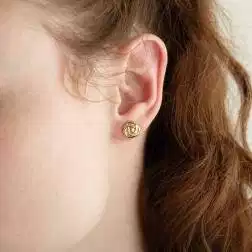 Photo of worn yellow gold rose earrings