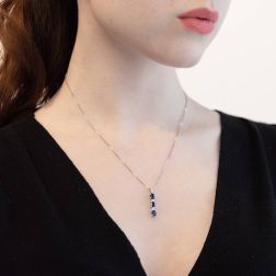 Photo of worn Trilogy Blue Sapphires and Diamonds Pendant