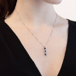 Photo of worn Trilogy Blue Sapphires and Diamonds Pendant