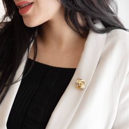 photo of worn 3+3 crossed circles brooch in 3 colors in 18kt gold