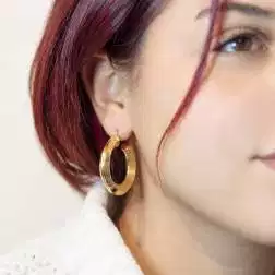 photo of worn Yellow Gold 3,4cm x 6,45mm Hoop Earrings with Grooved Arrow Shape and striped side