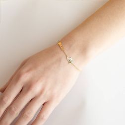 photo of worn Enamelled Bee and Flower Baby Bracelet with Yellow Gold Tag