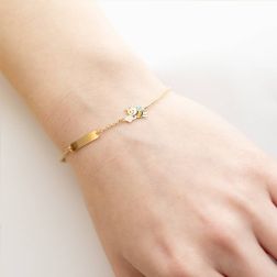 photo of worn Enamelled Bee and Flower Baby Bracelet with Yellow Gold Tag