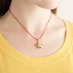 Photo of worn Eno the Alien Little Head Pendant Rose Gold