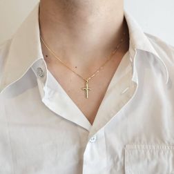 photo of worn Cross pendant with X on the center and grooves on the edges  in Yellow Gold
