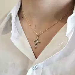 photo of worn Cross pendant with X on the center and grooves on the edges  in Yellow Gold