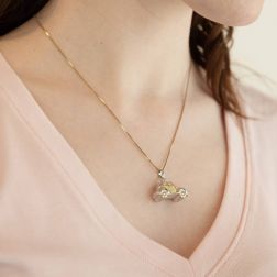 Photo of worn 3D Vintage Car Charm in 18kt white and yellow gold boxed structure