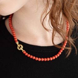 photo of worn Coral necklace round clasp in Yellow Gold