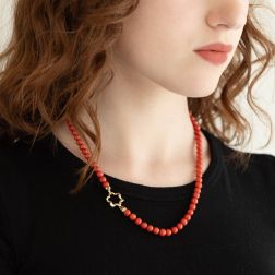 Photo of worn Coral flower clasp Necklace in Yellow Gold