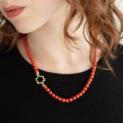 Photo of worn Coral flower clasp Necklace in Yellow Gold