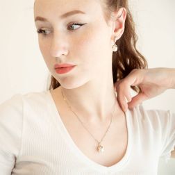 Photo of worn Freshwater pearl drop pendant earrings embracing