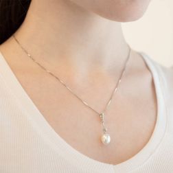 Photo of worn Freshwater oval pearl and cubic zirconia pendant