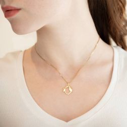 Photo of worn Fish Charm in 18kt yellow gold