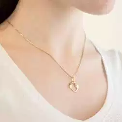 Photo of worn Fish Charm in 18kt yellow gold