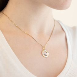 Photo of worn Wheel Rudder Pendant with Cardinal Points in Yellow and White Gold