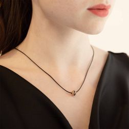 Photo of worn Perforated Hearts Sphere Pendant