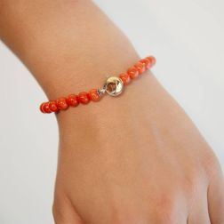 Photo of worn Coral bracelet round closure in two-tone gold
