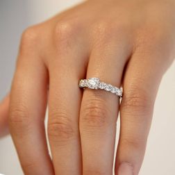 photo of worn Platinum solitaire ring with diamonds on the shank and central GIA diamond 0.61 ct.