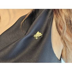 Photo of worn brooch grand piano in yellow gold