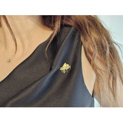 Photo of worn brooch grand piano in yellow gold