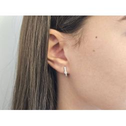 Photo of worn White Gold Oval Lobe Hoops with contoured Zircon