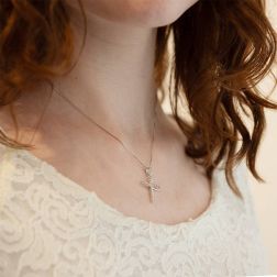 Photo of worn Stylized Infinity Cross pendent with zircons in white gold