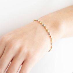 Photo of worn Bracelet with alternating barrels in 18kt Yellow, White and Rose Gold