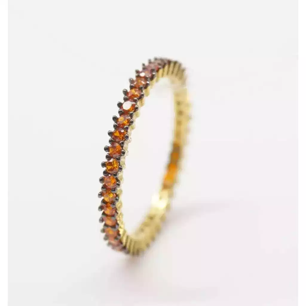 Eternity con zirconi arancio e brunitura