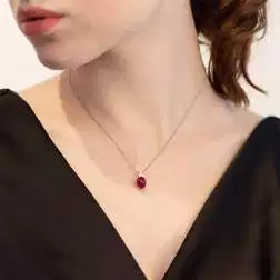 Photo of worn 18kt White Gold Red Oval 9,80x7,70mm Cabobochon Ruby and 3 Diamonds Necklace