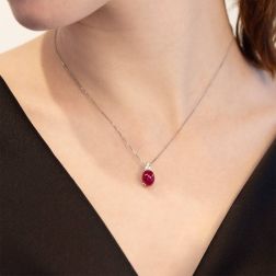 Photo of worn 18kt White Gold Red Oval 9,80x7,70mm Cabobochon Ruby and 3 Diamonds Necklace