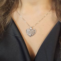 Photo of worn Domed Holed Heart shaped Charm 18kt white gold