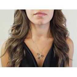 Photo of worn Stylized Flower Charm with Black and White zircons in Rose Gold