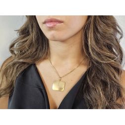 Photo of worn Satin Rectangular Medal in yellow gold