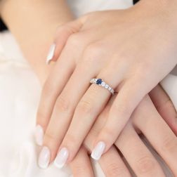 photo of worn Solitaire Ring surrounded by Sapphire and Diamonds in White Gold
