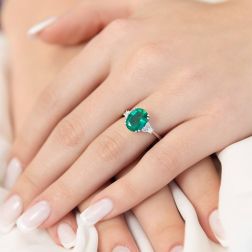 photo of worn Oval Emerald Solitaire and 6 Diamonds in White Gold