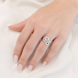 photo of worn Double Flower Diamonds and Emeralds Ring