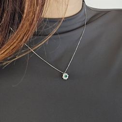 Photo of worn Flower Necklace with 0.12ct Emerald and Diamonds in White Gold