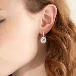 Photo of worn Kate earrings with 9x7mm Aquamarine and 50 Diamonds