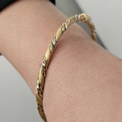 Photo of worn Satin and Polished Spiral Bracelet in Yellow and White Gold
