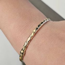 Photo of worn Hammered Rigid Bracelet in Yellow and White Gold