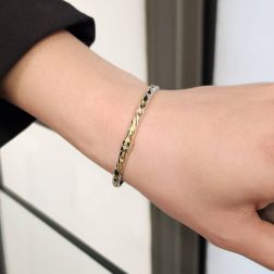 Photo of worn Hammered Rigid Bracelet in Yellow and White Gold