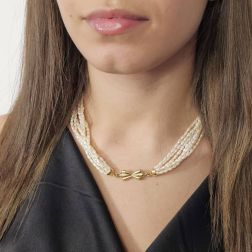 Photo of worn Strand Necklace with Oval Pearls and Bow attachment in Yellow Gold