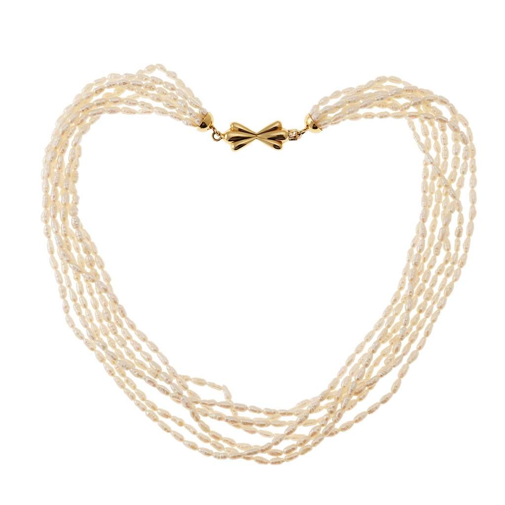 Strand Necklace with Oval Pearls and Bow attachment in Yellow Gold