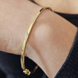 Photo of worn Polished and Satin Square Rigid Bracelet in Yellow and White Gold
